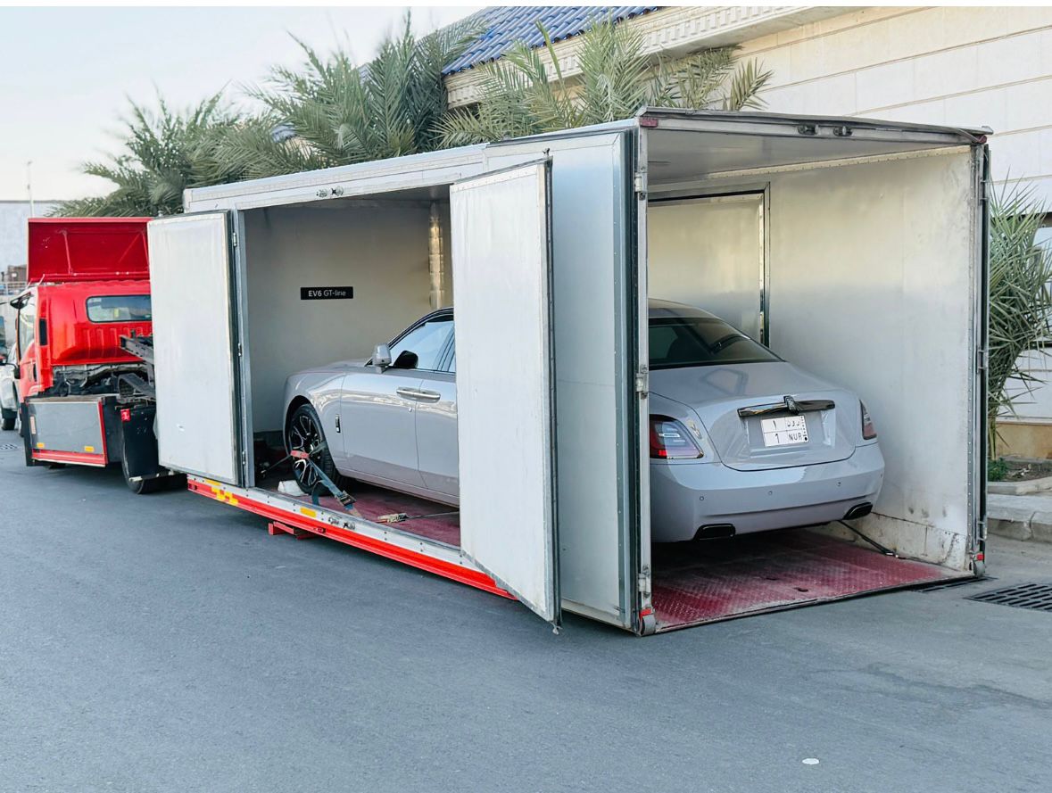 Luxury sedan secured inside the enclosed carrier